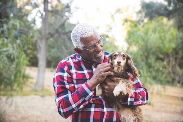 Older man holding dog